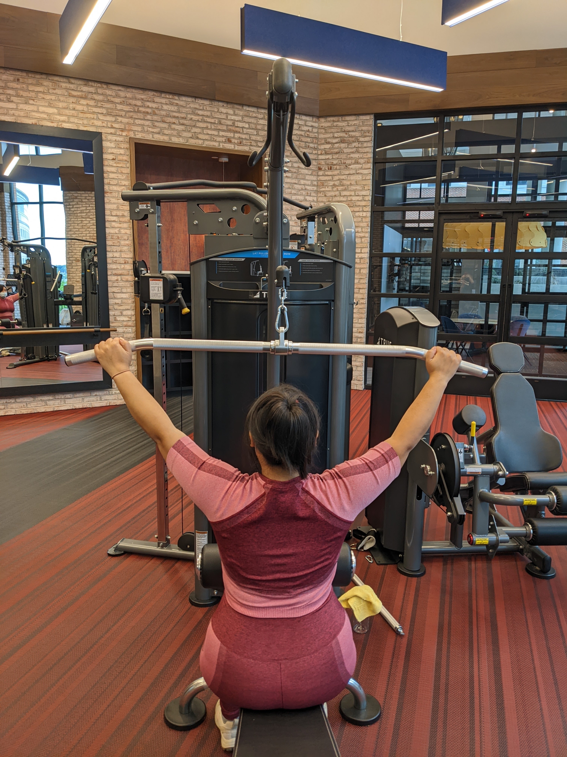 The Remy Apartments in New Carrollton woman using fitness equipment